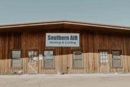 Southern AIR Heating & Cooling business storefront with tan and brown wooden facade, multiple windows and doors, and signage on the building.